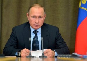 FILE - In this Monday, Nov. 9, 2015 file photo Russian President Vladimir Putin heads a meeting on military issues at the Russian Black Sea resort of Sochi, Russia. President Vladimir Putin's spokesman said plans for a new submarine-launched nuclear torpedo shown on Kremlin-controlled television were secret and should never have been aired. NTV and Channel One showed a large document  filmed over a military officer's shoulder during a meeting with Putin  with drawings and details of a weapons system called Status-6.  (Alexei Druzhinin/RIA Novosti, Kremlin Pool Photo via AP)