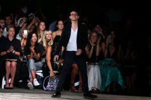 FILE - In this Saturday, Sept. 12, 2015, file photo, designer Christian Siriano acknowledges the audience after his Spring 2016 collection show during Fashion Week in New York. Siriano, Kelly Osbourne and Tim Gunn help teens make it work on "Project Runway Junior," which premieres Thursday, Nov. 12, 2015, at 9 p.m. Eastern on Lifetime. (AP Photo/Jason DeCrow, File)