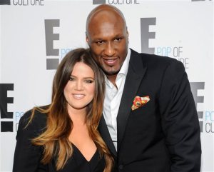 FILE - In this April 30, 2012, file photo, Khloe Kardashian Odom and Lamar Odom from the show "Keeping Up With The Kardashians" attend an E! Network upfront event at Gotham Hall in New York. Kardashian and Odom filed a petition to dismiss their divorce, but the reality TV star says that doesn't mean the pair is reconciling after Odom was found unconscious in a brothel. Odom was hospitalized in Las Vegas and transferred to Los Angeles, where his family said Oct. 22, 2015, that he was undergoing therapy and showing improvement. A clerk granted a request to dismiss their divorce filing from December 2013 in such a way that the divorce papers can be refiled at a later date. (AP Photo/Evan Agostini, File)