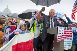 Democratic presidential candidate, Sen. Bernie Sanders, I-Vt. joins low-wage workers, some who labor as cooks and cleaners at the Capitol, as he speaks during a rally to protest what they describe as poverty pay, Tuesday, Nov. 10, 2015, on Capitol Hill in Washington.  (AP Photo/J. Scott Applewhite)