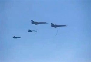 In this photo made from the footage taken from Russian Defense Ministry official web site on Tuesday, Nov. 17, 2015, Russian Tu-22 bombers escorted by the Su-27s fighter jets drop bombs on a target in Syria. Russia's defense minister said its warplanes have fired cruise missiles on militant positions in Syria's Idlib and Aleppo provinces. The Islamic State group has positions in Aleppo province; Idlib has the presence of the Nusra militant group.  (AP Photo/ Russian Defense Ministry Press Service)