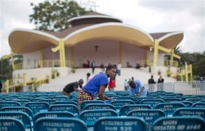 A cleaner washes metal chairs to be used by guests at the site where the Papal Mass will take place, in Nairobi, Kenya Tuesday, Nov. 24, 2015. The Kenyan government has declared a national public holiday Thursday on the day that Pope Francis is due to celebrate mass on the grounds of the University of Nairobi with large crowds expected to flock to the event. (AP Photo/Ben Curtis)