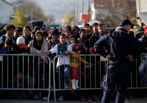 Migrants wait to register with the police at the refugee center in the southern Serbian town of Presevo, Monday, Nov. 16, 2015. Refugees fleeing war by the tens of thousands fear the Paris attacks could prompt Europe to close its doors, especially after police said a Syrian passport found next to one attackers body suggested its owner passed through Greece into the European Union and on through Macedonia and Serbia last month. (AP Photo/Darko Vojinovic)