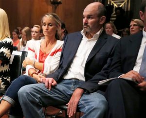 FILE - In this Wednesday, June 25, 2014, file photo, former NFL football player Kevin Turner, right, who suffers from Lou Gehrig's disease, listens during testimony before the Senate Special Committee on Aging hearing regarding concussions and the long term effects of brain related sports injuries in Washington. The NFL will ask a U.S. appeals court to uphold a potential $1 billion plan to settle thousands of concussion lawsuits filed by former players on Thursday, Nov. 19, 2015. (AP Photo/Charles Dharapak, File)