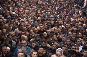 Palestinians walk in the funeral of Ahmed Abu al-Aish, 28, Laith Manasrah, 21,  in the Qalandia refugee camp on the outskirts of the West Bank city of Ramallah, Monday, Nov. 16, 2015.  Two Palestinians were killed and three wounded in clashes with Israeli troops early Monday in a Palestinian refugee camp in the Jerusalem area, a Palestinian health official said. The Israeli military said its troops entered Qalandia to demolish the home of a Palestinian who it says shot and killed an Israeli motorist in the West Bank this summer after he stopped to give the Palestinian directions to a nearby spring. (AP Photo/Majdi Mohammed)