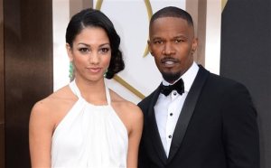 FILE - In this March 2, 2014 file photo, actor Jamie Foxx, right, and daughter Corinne, arrive at the Oscars at the Dolby Theatre in Los Angeles. The Hollywood Foreign Press Association announced Tuesday, Nov. 17, 2015, that Corinne Foxx will serve as Miss Golden Globe at the ceremony in January. The Golden Globes will be presented Jan. 10, 2016.  (Photo by Jordan Strauss/Invision/AP, File)