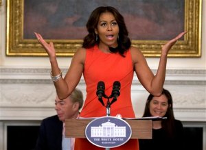 First lady Michelle Obama speaks during the Broadway at the White House event for high school students involved in performing arts programs in the State Dining Room of the White House in Washington, Monday, Nov. 16, 2015. Behind the first lady at left is composer Andrew Lloyd Webber and right is director Diane Paulus. (AP Photo/Carolyn Kaster)