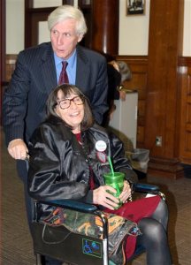 Linda Horan arrives with her lawyer Paul Twomey, rear, for a hearing at Merrimack County Superior Court Thursday, Nov. 12, 2015, in Concord, N.H.  Horan, in late-stage of lung cancer, seeks a court to provide her a medical marijuana identification card before dispensaries open next year in New Hampshire. The card would permit her to obtain marijuana in Maine, which serves patients who have registry cards in their home states. (AP Photo/Lynne Tuohy)
