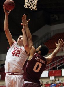 Utah forward Jakob Poeltl (42) goes to the basket against Temple forward Obi Enechionyia during the Puerto Rico Tip-Off college basketball tournament in San Juan, Sunday, Nov. 22, 2015. (AP Photo/Ricardo Arduengo)