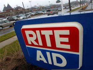 FILE - This Dec. 14, 2011, file photo, shows a Rite Aid sign at a store in Woodmere, Ohio. Rite Aid is giving patients a chance to peek over their doctor's shoulder with genetic tests that help determine the effectiveness of some prescriptions. The drugstore chain said Thursday, Nov. 12, 2015 that it is selling Harmonyx testing kits at nearly all of its stores. (AP Photo/Amy Sancetta, File)
