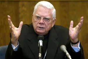 FILE - In this Aug. 2, 2002, file photo, Roman Catholic Church Cardinal  Bernard Law tetifies in Boston's Suffolk Superior Court, regarding his knowledge and handling of the child sex abuse case against the Rev. John Geoghan, and an alleged $30 million settlement from the Boston Archdiocese to be given to victims. More than a decade after the church was rocked by the clergy sex abuse scandal, Spotlight, a film that tells the story of how The Boston Globe exposed the scandal, is being released in theaters Nov. 6, 2015. (George Martell/Boston Herald via AP, Pool, File)
