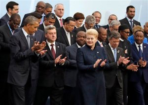 CORRECTS ID TO LITHUNIA PRESIDENT U.S. President Barack Obama, left, and Lithuania's President Dalia Grybauskaite, front row third from right, applaud as they pose with world leaders for a group photo at the COP21, United Nations Climate Change Conference, in Le Bourget, outside Paris, Monday, Nov. 30, 2015. (AP Photo/Jacky Naegelen, Pool)