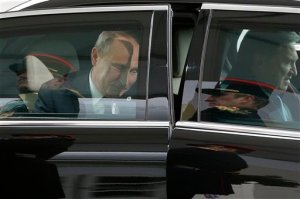 The honor guards are reflected in the limousine carrying Russian President Vladimir Putin, center left, as he arrives for the COP21, United Nations Climate Change Conference, in Le Bourget, outside Paris, Monday, Nov. 30, 2015. (AP Photo/Christophe Ena, Pool)