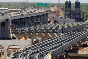 FILE - In this May 17, 2012, file photo, the steel skeleton for the eastern end of the new Innerbelt Bridge in Cleveland sits next to the existing span. The House on Thursday voted overwhelmingly in favor of final passage of a 5-year, $305 billion bill that boosts highway and transit spending and provides states with assurance that federal help will be available for major projects. Senate action is expected to follow shortly.  (AP Photo/Mark Duncan, File)