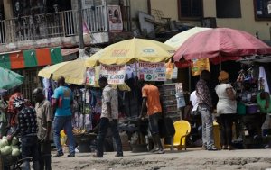 In this photo taken Tuesday, Nov. 17, 2015, people register their sim cards under an MTN company umbrella on a roadside in Lagos, Nigeria.  Nigeria's authorities have levied a US dlrs 5.2 billion fine to Africas largest telecommunications company, MTN, for having 5.2 million active but unregistered SIM cards, which authorities allege are a matter of national security in Nigeria and may have caused deaths.  The dlrs 5.2 billion fine is far more than any company has been fined anywhere in the world according to industry expert John Strand of Denmark-based Strand Consult. (AP Photo/Sunday Alamba)