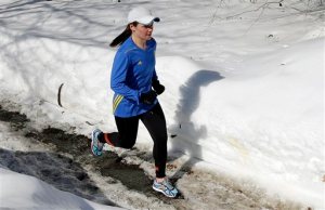 In this Feb. 27, 2015 photo, Becca Pizzi trains for the Boston Marathon along Heartbreak Hill in Newton, Mass. Pizzi, a veteran of 45 marathons, vies to be the first American woman to complete the World Marathon Challenge -- seven marathons in seven days on seven continents -- in January 2016.  (AP Photo/Elise Amendola)