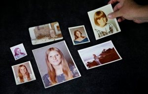 In this Thursday, June 11, 2015 photo, Lisa Long lays out family photos of her sister Karen Barnes in Jonesboro, Ga. The married couple dubbed the San Francisco witch killers seemed locked away for good when each was sentenced to 75 years to life for three murders, including Barnes' 30 years ago. Because California prisons are under court order to ease severe overcrowding, a parole board will consider whether the wife Suzan Carson, 73, is fit for release Wednesday, Dec. 2. Long has traveled to Chino, Calif., to testify against Suzans release. They are unrepentant, Long said. (AP Photo/David Goldman)