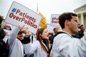 FILE - In this March 4, 2015 file photo, demonstrators chant during  health care rally outside the Supreme Court in Washington. The Supreme Court appears skeptical that state officials have the power to require health insurers to turn over reams of data revealing how much they pay for medical claims.  (AP Photo/Andrew Harnik, File)