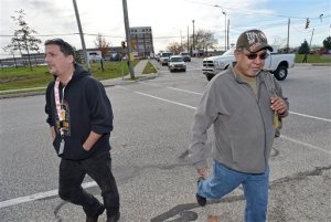 John Randolph, left, and Tony Mendez, right, leave the GE Transportation manufacturing plant, Friday, Nov. 6, 2015, in Lawrence Park Township, near Pa., through the Water Street gate at the conclusion of their work shifts. GE Transportation announced Friday, they are laying off one-third of its 4,500 workers at a locomotive manufacturing plant in northwestern Pennsylvania. (Christopher Millette/Erie Times-News via AP)  MANDATORY CREDIT; MAGS OUT