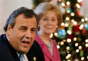 Former New Hampshire House Speaker Donna Sytek listens at right as Republican presidential candidate, New Jersey Gov. Chris Christie speaks at a drug recovery round table at Hope For Recovery, Tuesday, Dec. 1, 2015, in Manchester, N.H. Sytek endorsed Christie's presidential campaign. (AP Photo/Jim Cole)