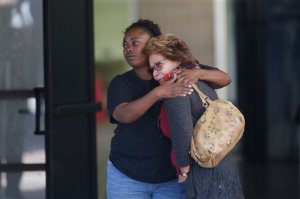 Two women embrace at a community center where family members are gathering to pick up survivors after a shooting rampage that killed multiple people and wounded others at a social services center in San Bernardino, Calif., Wednesday, Dec. 2, 2015. (AP Photo/Jae C. Hong)