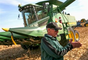 In this Oct. 19, 2015 photo, farmer Dave Kestel speaks with a truck driver hauling grain in New Lenox, Ill. According to a July 2015 report by the USDA, agricultural output across the nation more than doubled since 1948, with less land. Harvesting crops is an intensive process. But new technology is making farming easier. (Eric Ginnard/The Herald-News via AP)  CHICAGO TRIBUNE OUT, MANDATORY CREDIT