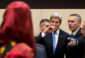 U.S. Secretary of State John Kerry, center, is guided by NATO Secretary General Jens Stoltenberg, second right, during a round table meeting of Resolute Support at NATO headquarters in Brussels on Tuesday, Dec. 1, 2015. U.S. Secretary of State John Kerry and other NATO foreign ministers meet Tuesday to discuss Russia, beefing up the alliance's southern defenses and whether to expand NATO by adding Montenegro to the NATO Alliance. (AP Photo/Virginia Mayo)