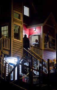 In this photo taken Monday night, Nov. 30, 2015, Juneau Police Chief Bryce Johnson talks with detectives at the front door of Mayor Stephen "Greg" Fisk's home in Juneau, Alaska. Fisk, the newly elected mayor of Alaska's capital city, was found dead in his home Monday. Circumstances surrounding the death were not immediately known.  (Michael Penn/The Juneau Empire via AP) MANDATORY CREDIT