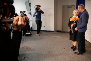 Michael Hochberg, right, talks with Krystyna Jakubowski while surrounded by reporters at John F. Kennedy International Airport in New York, Wednesday, Dec. 2, 2015. The Jakubowski family sheltered Hochberg for more that two years during the Holocaust. They two were brought back together by the The Jewish Foundation for the Righteous. (AP Photo/Seth Wenig)