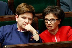 Polands Prime Minister Beata Szydlo,left, listens to a debate in the Parliament next to prominent member of the ruling Law and Justice party, and lawmaker Elzbieta Witek, right, in Warsaw, Poland on Wednesday, Jan. 13, 2016. Polands prime minister says that the nations democracy is doing well while European Union leaders are debating the rule of law under her right-wing government. The European Council is debating opinions that democracy and media freedom in Poland are threatened by new legislation that the ruling Law and Justice party, in power since November, adopted on state broadcasters and the Constitutional Tribunal. (AP Photo/Czarek Sokolowski)