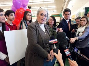 Rebecca Hargrove, center, president & CEO of the Tennessee Lottery, makes the announcement at Naifeh's supermarket in Munford, Tenn., Thursday, Jan. 14, 2016, that the store sold one of three winning tickets in the record Powerball jackpot. The holder of the winning ticket will share the $1.6 billion jackpot with winners in Southern California and Florida. (AP Photo/Karen Pulfer Focht)