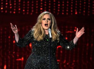 FILE - In this Feb. 24, 2013 file photo, singer Adele performs during the Oscars at the Dolby Theatre in Los Angeles. Adele has outpaced Psy on the race to 1 billion views on YouTube. The streaming service announced on Thursday, Jan. 21, 2016, that the music video for "Hello" greeted its 1 billionth view in 87 days, breaking the 158-day record previously held by Psys "Gangnam Style." (Photo by Chris Pizzello/Invision/AP, File)