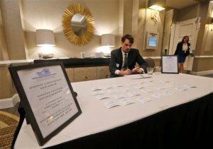 Senate Democratic aids staff a welcoming table at the entrance to a closed fund raising breakfast in Richmond, Va., Tuesday, Jan. 12, 2016. Virginia lawmakers kept busy before the start of the 2016 legislature raising money from the businesses and trade associations that lobby them, donations that wont be made public until long after the session is over. (AP Photo/Steve Helber)