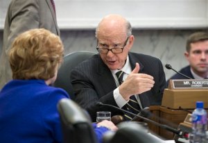 Senate Agriculture Committee Chairman Sen. Pat Roberts, R-Kansas, right, talks to the committee's ranking member Sen. Debbie Stabenow, D-Mich., on Capitol Hill in Washington, Wednesday, Jan. 20, 2016, as the panel voted to approve new measures to set fat, sugar and sodium limits in school lunches. (AP Photo/J. Scott Applewhite)