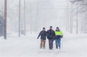 Three men walk down Adams Street on Friday, Jan. 22, 2016, in Bowling Green, Ky.  A massive blizzard began dumping snow on the southern and eastern United States on Friday, with mass flight cancelations, five states declaring states of emergency and more than two feet (60 centimeters) predicted for Washington alone. Blizzard warnings or watches were in effect along the storm's path, from Arkansas through Tennessee and Kentucky to the mid-Atlantic states and as far north as New York.  (Austin Anthony/Daily News via AP) MANDATORY CREDIT