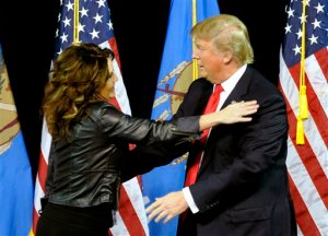 Former Republican vice presidential candidate Sarah Palin and hugs Republican presidential candidate Donald Trump after she introduced him in Tulsa, Okla., Wednesday, Jan 20, 2016. (AP Photo/Brandi Simons)