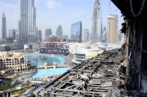 This undated handout image from the Dubai police, provided Wednesday, Jan. 20, 2016, at their news conference on The Address Downtown fire, shows the exterior of the building after the New Years Eve blaze that engulfed the 63-story skyscraper in Dubai. In announcing the cause, Dubai's police chief Maj. Gen. Khamis Mattar al-Mazeina said investigators ruled out any criminal cause for the fire at The Address Downtown. (Dubai Police via AP)