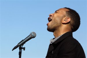 John Legend performs on a flat bed truck platform during a concert with Colombian rock star Juanes, in front of a detention center in Eloy, Arizona, Wednesday, Jan. 20, 2016.  Legend and Juanes played two songs each separately and one together at the facility, to draw attention to immigration. (AP Photo/Ricardo Arduengo)
