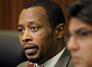 In this Oct. 25, 2011 photo, City Treasurer and former Vice Mayor of Norfolk, Va., Anthony Burfoot appears at a council meeting, in Norfolk, Va. A federal grand jury has indicted Burfoot on public corruption charges. (Amanda Lucier /The Virginian-Pilot via AP) MAGS OUT; MANDATORY CREDIT