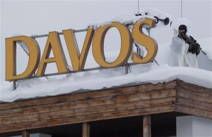 A police officer patrols on a roof top of a Hotel near the congress center where the World Economic Forum will start on Wednesday in Davos, Switzerland, Tuesday, Jan. 19, 2016. The world's political and business elite are being urged to do more than pay lip service to growing inequalities around the world as they head off for this week's World Economic Forum in the Swiss ski resort of Davos. (AP Photo/Michel Euler)