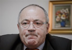 In this photo taken on Thursday, Jan. 14, 2016, journalist and former senator Sorin Rosca Stanescu listens during a class lecture at the Diplomatic Academy in Bucharest, Romania. Romanias crackdown on corruption and fraud in recent years has created a sudden and unexpected literary boom, as prisoners publish hundreds of non-fiction books on subjects as varied as soccer, real estate, God and gemstones. (AP Photo)