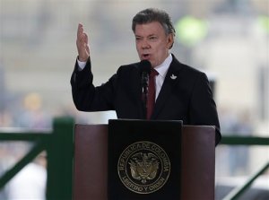 In this photo taken Nov. 6, 2015, Colombia's President Juan Manuel Santos speaks at the rebuilt Palace of Justice in Bogota, Colombia. The White House says President Barack Obama will meet with the President Santos in February to show support for a potential peace agreement in that country. The meeting on Feb. 4 would come about seven weeks before a deadline in peace talks between Colombia's government and the Revolutionary Armed Forces of Colombia, or FARC. (AP Photo/Fernando Vergara)