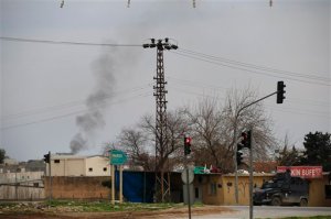 Smoke billows from a fire at the southeastern town of Nusaybin, Turkey, near the border with Syria, where Turkish security forces are battling militants linked to the outlawed Kurdistan Workers, Party or PKK, Sunday, Feb. 14, 2016, a day after Turkish media reports said a police officer was injured in a clash. The private Dogan news agency said the militants on Saturday detonated an explosive device in the town as a military vehicle was passing by, but no one injured. A second bomb was defused in a controlled explosion. (AP Photo/Lefteris Pitarakis)