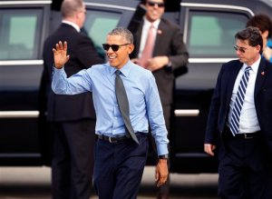 President Barack Obama walks over to the crowd before departing on Air Force One at Moffett Federal Airfield Thursday, Feb. 11, 2016, in Mountain View, Calif. Obama will fly to Los Angeles for more DNC fund raisers, as well as a appearance on comedian Ellen DeGeneres' show. (AP Photo/Tony Avelar)
