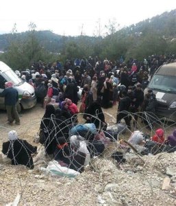 In this image taken Wednesday, Feb. 3, 2016 Syrians wait to enter Turkey at the Bab al-Salam border gate, Syria. Turkish officials say thousands of Syrians have massed on the Syrian side of the border seeking refuge in Turkey. Officials at the governments crisis management agency said Friday Feb. 5, 2016 that it was not clear when Turkey would open the border to allow the group in and start processing them.  (Depo Photos via AP) TURKEY OUT