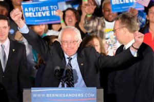 Democratic presidential candidate, Sen. Bernie Sanders, I-Vt., reacts to the cheering crowd at his primary night rally Tuesday, Feb. 9, 2016, in Manchester, N.H. (AP Photo/J. David Ake)
