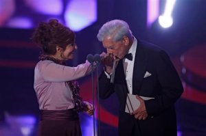 Peru's Nobel Literature Prize laureate Mario Vargas Llosa, right, kisses the hand of Spanish writer Elvira Lindo during the Goya Film Awards Ceremony in Madrid, Spain, Saturday. Feb. 6, 2016. The Goya Awards are Spain's main national annual film awards. (AP Photo/Francisco Seco)