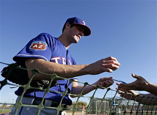 FILE - In this Feb. 21, 2016, file photo, Texas Rangers pitcher Cole Hamels signs autographs during spring training baseball practice, in Surprise, Ariz. Cole Hamels struck out trying to see last years Victorias Secret Fashion Show, and hes suing a London-based event promoter over it. The former Philadelphia Phillies star filed the lawsuit in Philadelphia on Friday, Feb. 19, 2016. He alleges Cornucopia Events failed to get him and his wife into the 2015 New York City lingerie show even though he paid nearly $70,000 for three VIP packages.(AP Photo/Charlie Riedel)