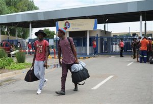 Students leave the campus at the North-West University in Mahikeng, South Africa, (also known as Mafikeng) Thursday, Feb. 25, 2016. Protesting students burned down several buildings on the campus Wednesday forcing the evacuation and indefinite closure till further notice a spokesman said Thursday. (AP Photo)