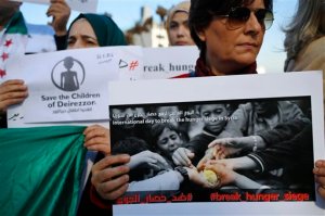Anti-Syrian government activists hold up placards during a sit-in against the ongoing siege imposed on the Syrian town of Madaya in front of the European Union embassy in Beirut, Lebanon, Saturday, Jan. 16, 2016. Government troops and allied militiamen have blockaded the rebel-held Syrian town of Madaya near Damascus for months. Doctors Without Borders said later that five people died of starvation after the first U.N. humanitarian aid convoy since October arrived in Madaya on Tuesday afternoon. (AP Photo/Hassan Ammar)